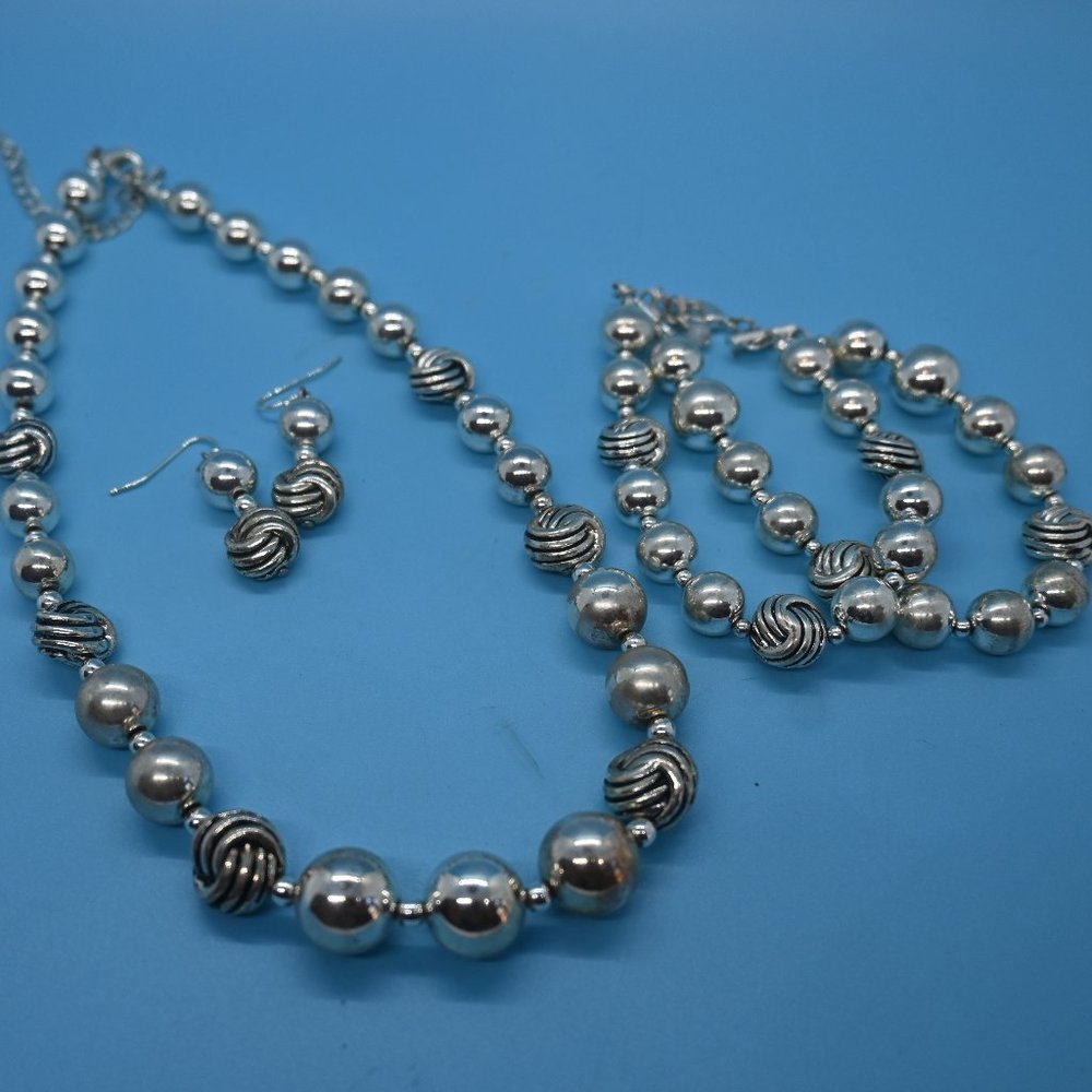 Bundle of necklaces along with one bracelet and one pair of earrings.